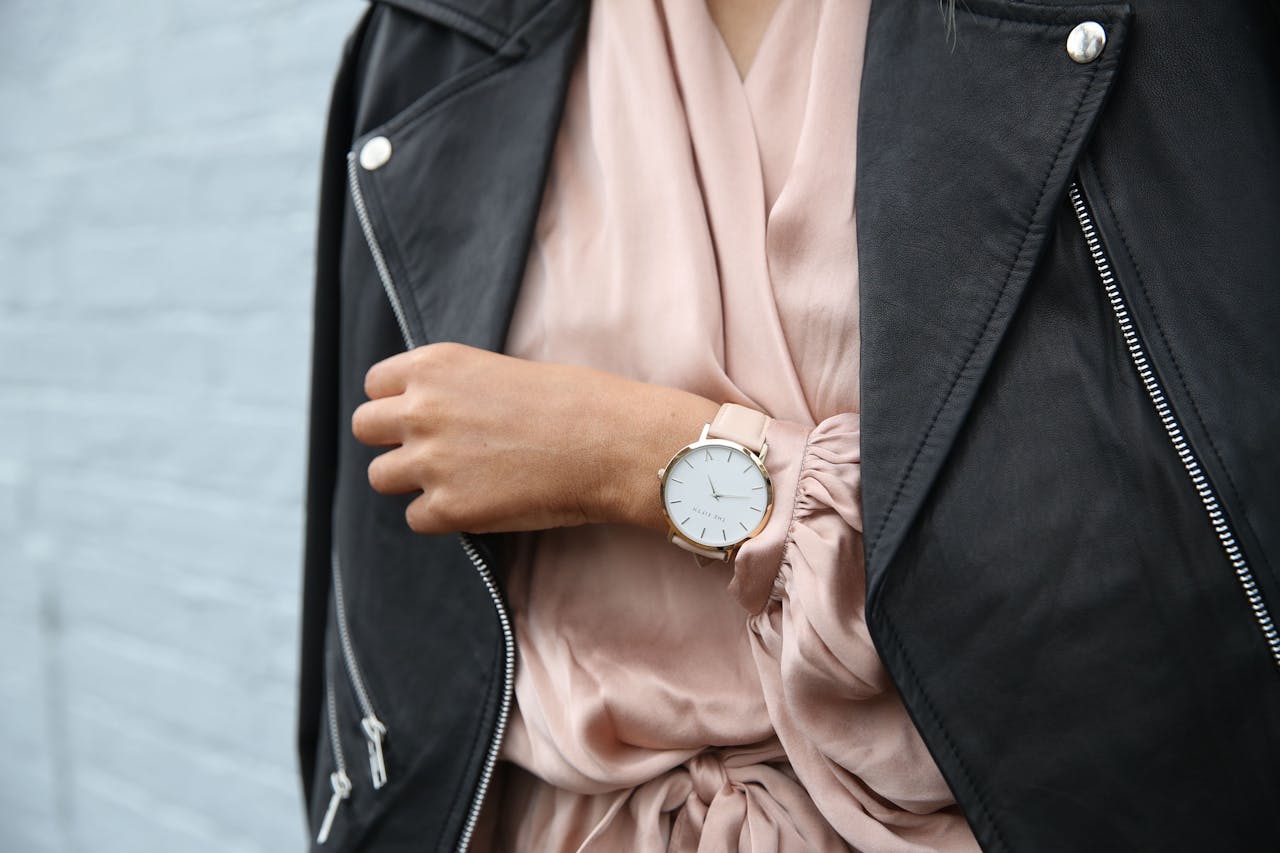menu-05 Stylish woman in a leather jacket showcasing an elegant wristwatch, perfect for fashion-forward individuals.